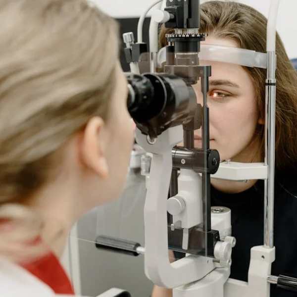 Patient undergoing slit lamp eye exam - Acuity Health Solutions