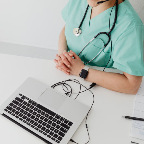 Telehealth clinician on laptop with headset - Acuity Health Solutions