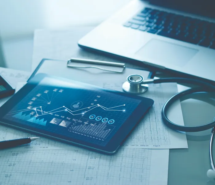 Medical analytics on tablet with stethoscope - Acuity Health Solutions